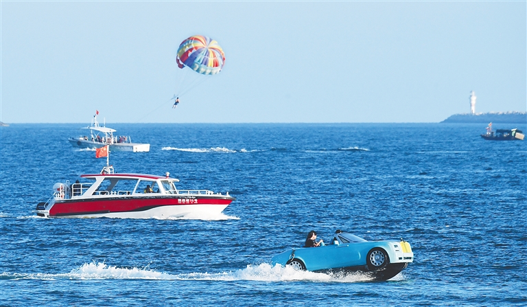 10月1日，游客在三亚大东海景区体验海上项目。新华社记者 赵颖全 摄
